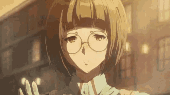 a girl with short brown hair and glasses is standing in front of a building in a city .