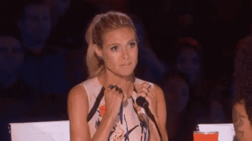 a woman is sitting in front of a microphone and making a face .