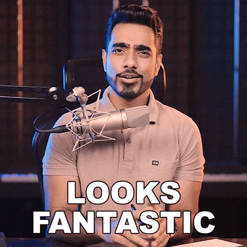 a man sitting in front of a microphone with the words " looks fantastic " below him