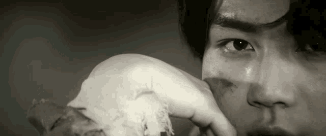 a black and white photo of a man holding a skull .