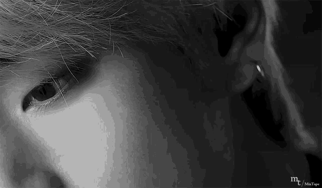 a close up of a person 's eye and ear with a piercing .
