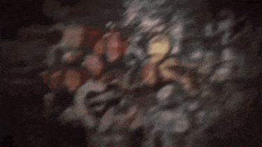 a group of boxes are flying through the air in a dark room .