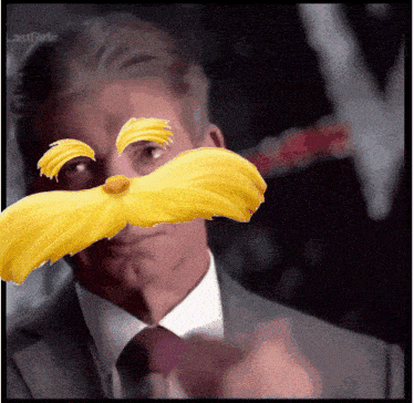 a man in a suit and tie has a yellow mustache on his face