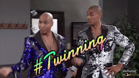 two men in sequined suits are standing next to each other and the words #twinning are written on the screen