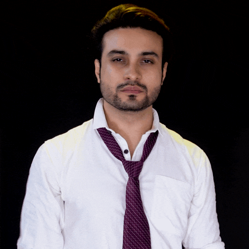 a man in a white shirt and purple tie