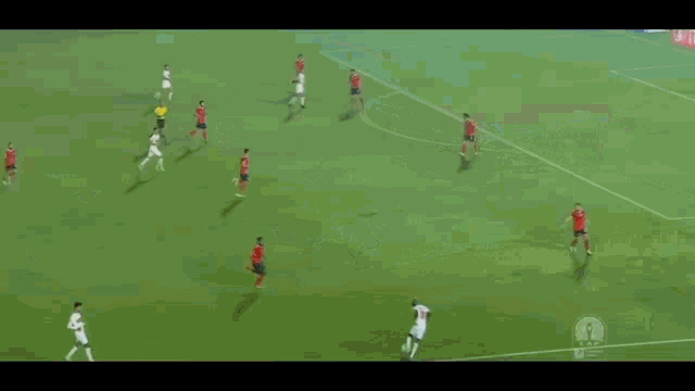 a soccer game is being played on a field with a yellow referee in the background