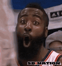 a man with a beard is making a surprised face with his mouth open