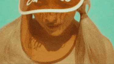a close up of a woman wearing a visor with the word california on it