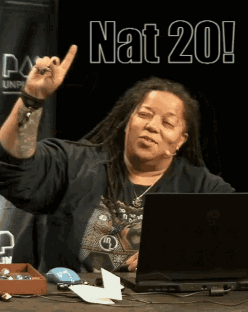 a woman sitting in front of a laptop with the words nat 20 written on it