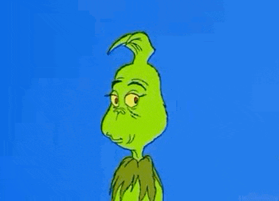 the grinch is a cartoon character with a very angry face and a blue background .