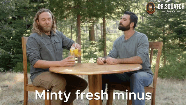 two men are sitting at a table with the words minty fresh minus on the bottom