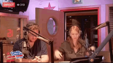 a man and a woman are in front of microphones in a studio that says camille combat virgin radio