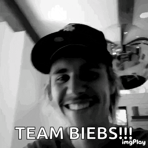 a black and white photo of justin bieber with the words team biebs written below him
