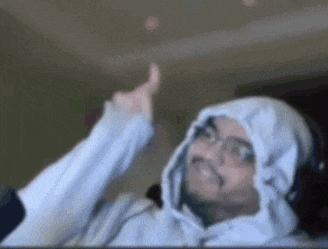 a man in a hoodie is giving a thumbs up .