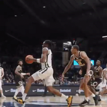 a basketball player with the number 1 on his jersey is dribbling a ball
