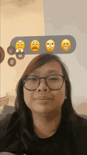 a woman wearing glasses has four emojis on her head including one that says angry