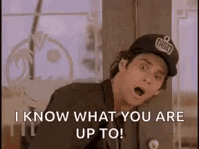 a man wearing a baseball cap is standing in front of a door and says `` i know what you are up to ! ''