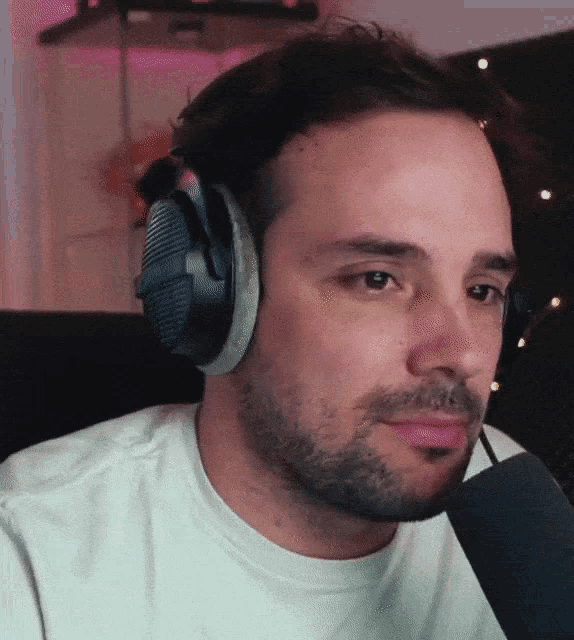 a man wearing headphones and a white shirt