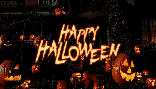 a happy halloween sign with pumpkins in the background