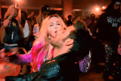 a man wearing a black rescue me shirt is dancing with a woman