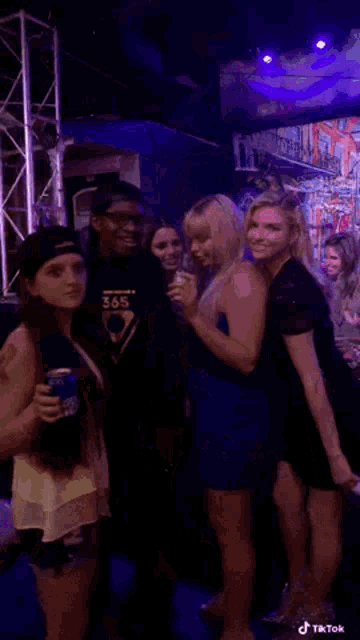 a man is holding a can of bud light in his hand