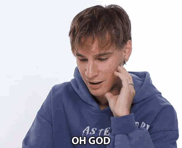 a man wearing a blue hoodie that says aste on it