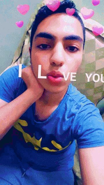 a young man wearing a blue shirt that says " i love you " on it