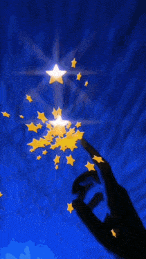 a hand is pointing at a star that is shining in the sky
