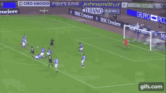 a soccer goalie is diving to catch a ball on a field