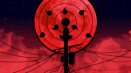 a silhouette of a telephone pole in front of a red moon