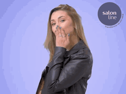 a woman with her mouth open is standing in front of a salon line logo