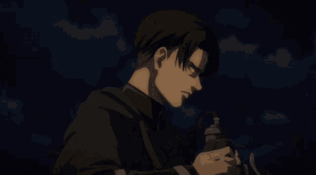 a man in a cape is holding a gun in his hand in a dark room .