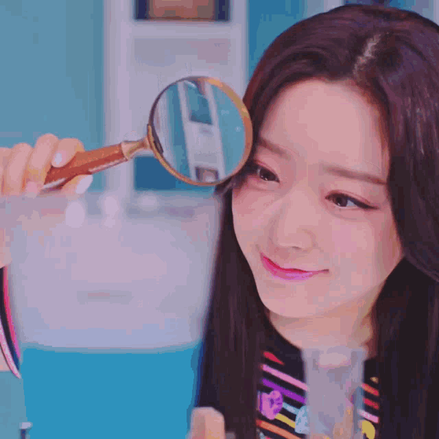 a woman looks through a magnifying glass at something