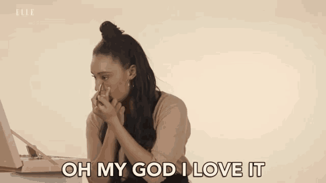 a woman is sitting in front of a record player and saying `` oh my god , i love it '' .