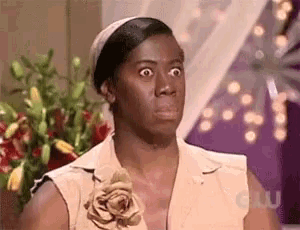 a woman with a flower on her chest is making a funny face