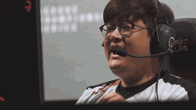 a man wearing glasses and headphones is sitting in front of a pet lab chair