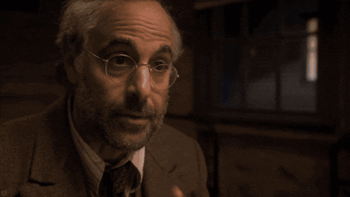 a man wearing glasses and a suit says knows the value of strength