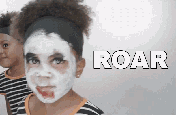 a little girl with her face painted and the word roar written on the bottom