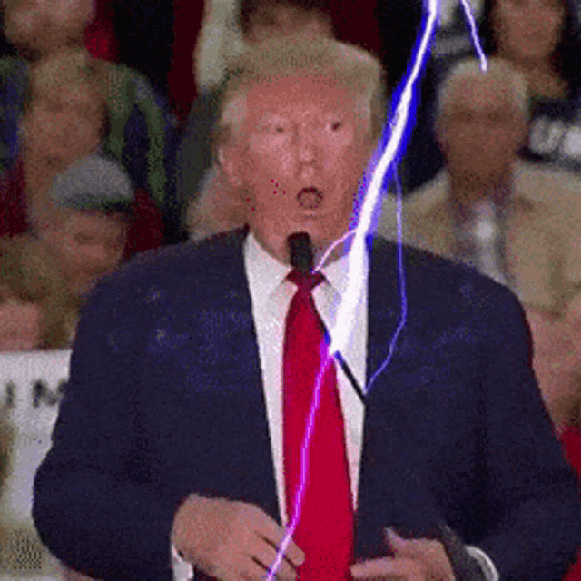 a man in a suit and tie is giving a speech