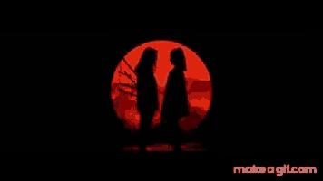 two women are standing in front of a red circle in the dark .