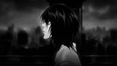 a black and white photo of a boy with long hair standing in front of a city .