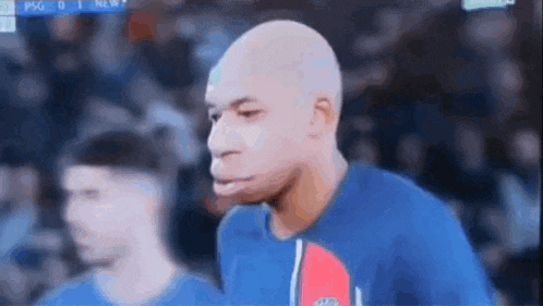 a soccer player is making a funny face during a game on a television .