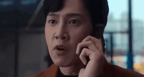 a man is talking on a cell phone while making a funny face .