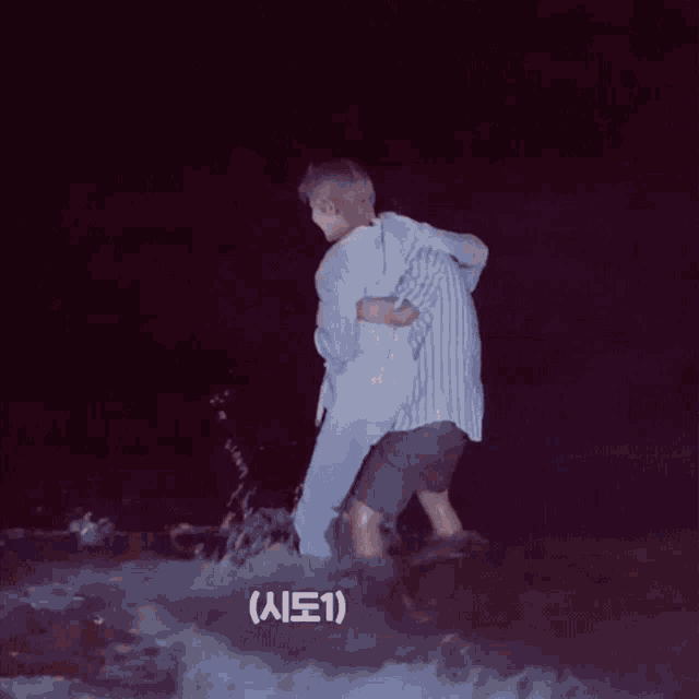 a man is carrying another man in the water with chinese writing on the bottom right
