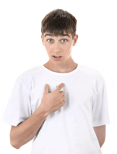 a young man in a white t-shirt is pointing to his chest