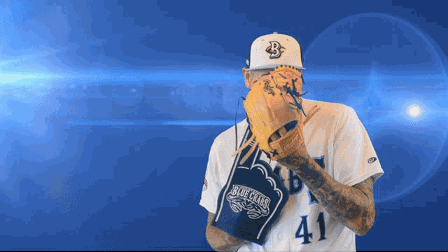 a baseball player wearing a blue crabs glove
