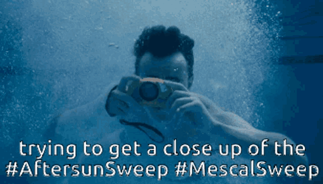 a man is taking a picture underwater with the caption trying to get a close up of the #aftersunsweep