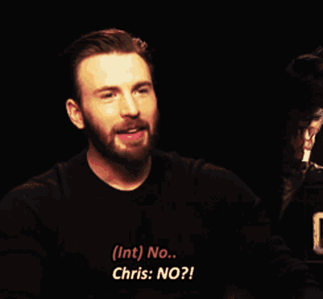 a man with a beard is wearing a black shirt that says ( int ) no chris : no ?