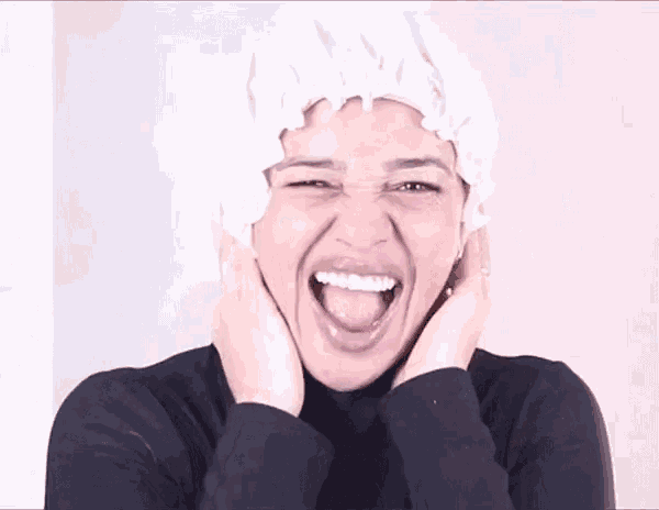 a woman wearing a shower cap is making a funny face .