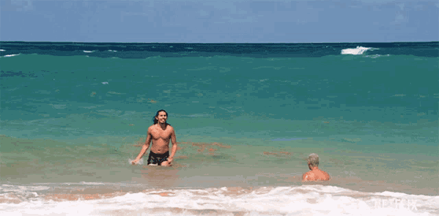 two men are swimming in the ocean with netflix written on the bottom right